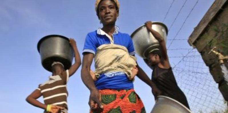 Felicia Ayaawin draws water from the well Oxfam’s partner installed near her home in Kpatua. 