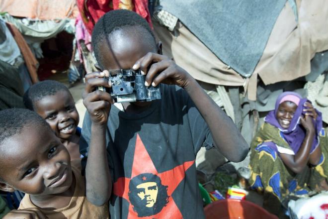 There are still an estimated 369,000 people living in camps for internally displaced people in and around Mogadishu. Despite the challenging conditions, children manage to entertain themselves – in this case by making fun of the photographer! Children in a camps for internally displaced people, Mogadishu. Photo credit: Petterik Wiggers.