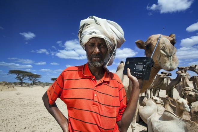 To create awareness about the access to education for women, Oxfam and long time partner TASS (tadamun.org) organized a radio debate on Daljir FM to provoke discussions about gender inequality. The phone lines were open for the public to share their view. Hussein Mohammed listens to the BBC Somali service on his radio while his camels stop for water. Radio is often the main source of information for people in rural areas. Photo: Petterik Wiggers.