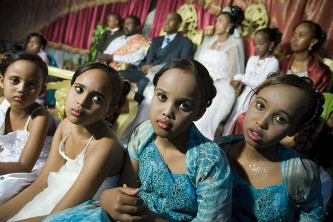 Girls at a wedding ceremony. Somali weddings are joyous occasions of feasting and poetry that bring together families and friends in a celebration of life lasting several days. Girls sitting at a wedding ceremony, in Somalia. Photo credit: Petterik Wiggers.