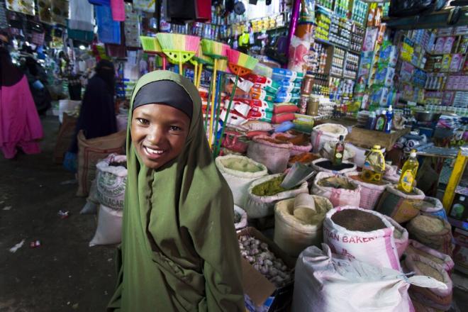 A young girl chooses from an array of goods at the market in Hargeisa, Somaliland. A young girl at the market in Hargeisa, Somaliland. Photo credit: Petterik Wiggers.