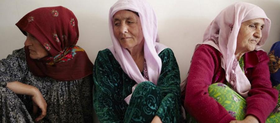 Women sit together in Tajikistan where we are working to raise awareness of gender based violence. Photo: Andy Hall Women sit together in Tajikistan
