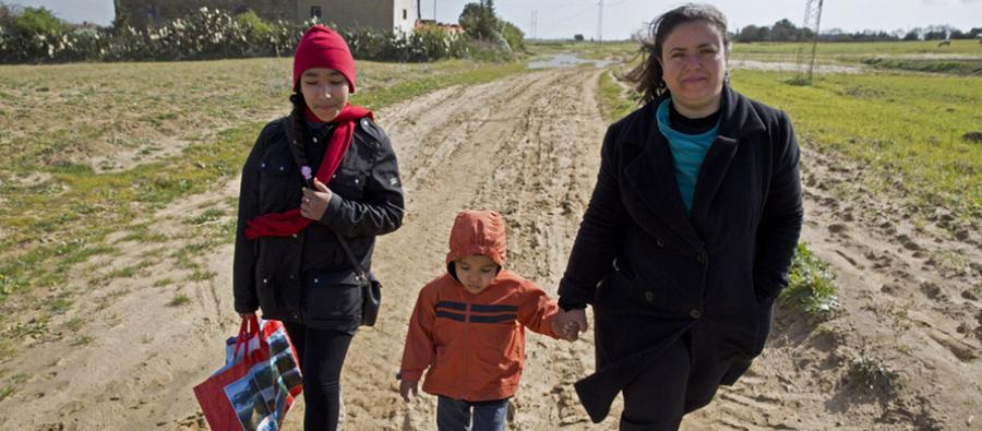 Ahlem Ben Ahmend walks home with her son through the fields on a windy day after visiting the HealthCare Centre in the local village Azmoure, Tunisia. Ahlem Ben Ahmend walks home with her son through the fields on a windy day after visiting the HealthCare Centre in the local village Azmoure, Tunisia.