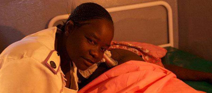 Sister Mandava and Dianna Mcgapa, demonstrate the difficulties of working by candle light at the Mazuru clinic back in 2011 when there was no electricity. Credit: Annie Bungeroth/Oxfam Sister Mandava and Dianna Mcgapa, demonstrate the difficulties of working by candle light at the Mazuru clinic back in 2011 when there was no electricity. Credit: Annie Bungeroth/Oxfam