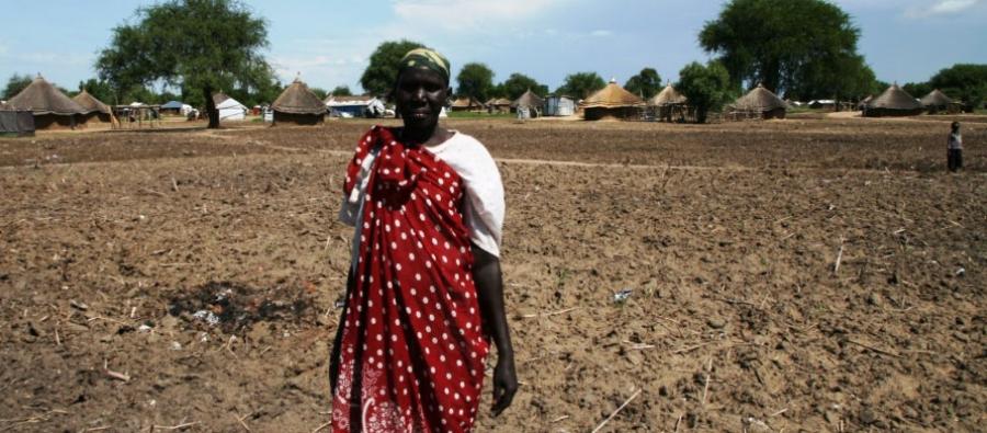 A woman stands on land prepared for cereal cultivation in South Sudan. Nick Lacey/Oxfam A farmer stands on her prepared land in South Sudan