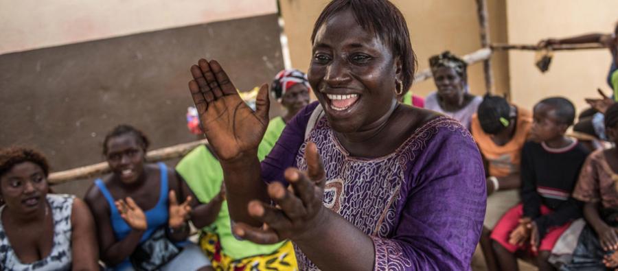 Isatu Kamara, 40, leads oxfam volunteers and the community in a song to thank Oxfam for their intervention during the Ebola outbreak. Sierra Leone, April 2015. Photo:Tommy Trenchard/Oxfam Isatu Kamara, 40, leads oxfam volunteers and the community in a song to thank Oxfam for their intervention during the Ebola outbreak. Sierra Leone, April 2015. Photo:Tommy Trenchard/Oxfam