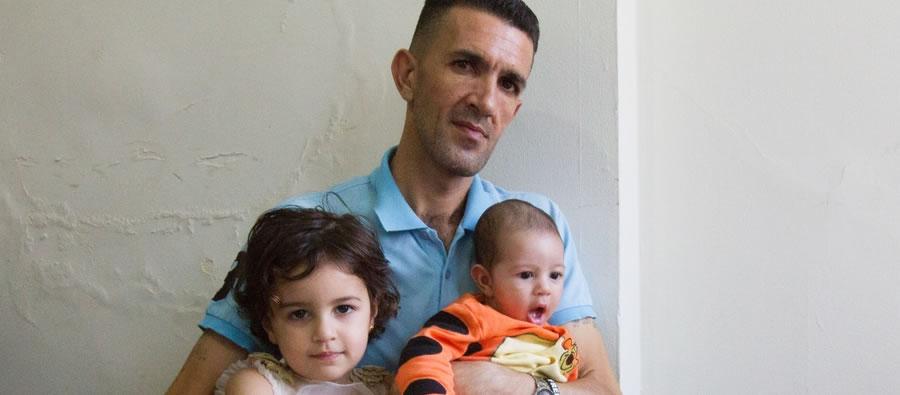 Ahmed Abizaid, with two of his five children, is working to build a new life for himself and his family in a Chicago suburb after fleeing the violence in Syria. Photo credit: Coco McCabe Ahmed Abizaid, with two of his five children, is working to build a new life for himself and his family in a Chicago suburb after fleeing the violence in Syria. Photo credit: Coco McCabe