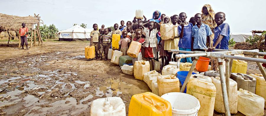Children and women queue at the water points to pump water at the Jamam refugee camp. Photo credit: John Ferguson Children and women queue at the water points to pump water at the Jamam refugee camp. Photo credit: John Ferguson