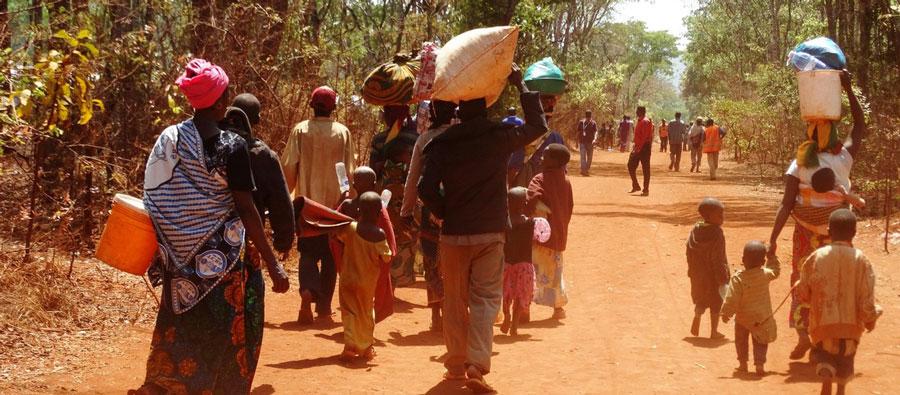 Burundian refugees walking from the arrival point to their “reception village” where they will wait to be assigned their new shelter Burundian refugees walking to their new reception village