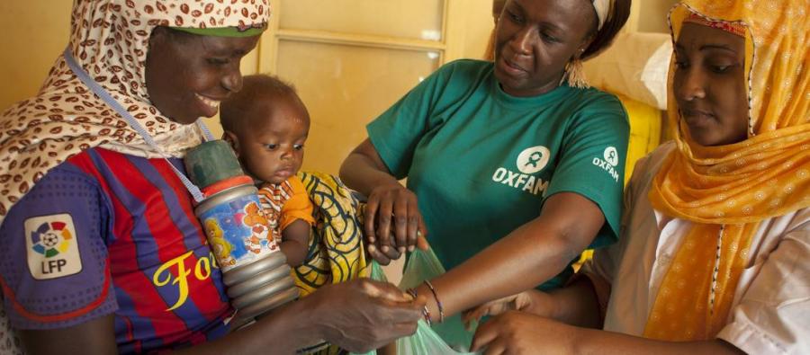 A mother and her child who’s suffering with malnutrition, receive a hygiene kit. Kits and practice of good hygiene can reduce treatment duration for a child with moderate malnutrition from four to two weeks. Photo credit: Abbie Trayler-Smith/Oxfam A mother and her child who’s suffering with malnutrition, receive a hygiene kit. Kits and practice of good hygiene can reduce treatment duration for a child with moderate malnutrition from four to two weeks. Photo credit: Abbie Trayler-Smith/Oxfam