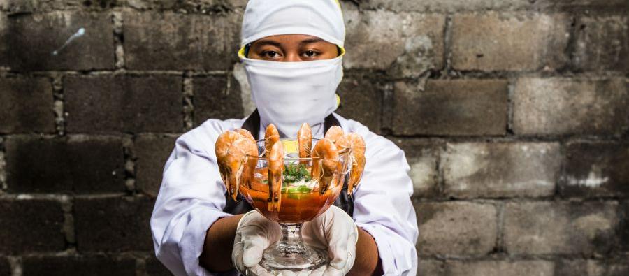 Melati, 18, worked in an Indonesian shrimp factory. She was expected to peel 600 shrimps an hour. When cleaning the conveyor belt with a chlorine mixture, she burned her hands because she was not given the proper safety equipment. Photo: Adrian Mulya. Melati, 18, worked in an Indonesian shrimp factory. She was expected to peel 600 shrimps an hour. When cleaning the conveyor belt with a chlorine mixture, she burned her hands because she was not given the proper safety equipment. Photo: Adrian Mulya.