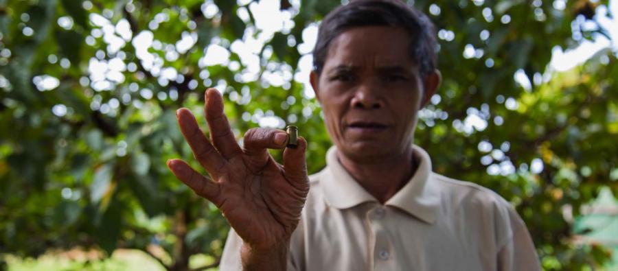 Sal Hnok holds a shell casing from a bullet fired at him when he insisted workers stop clear cutting the forest near his village in northern Cambodia. Photo: Savann Oeurm/Oxfam Sal Hnok holds a shell casing from a bullet fired at him when he insisted workers stop clear cutting the forest near his village in northern Cambodia